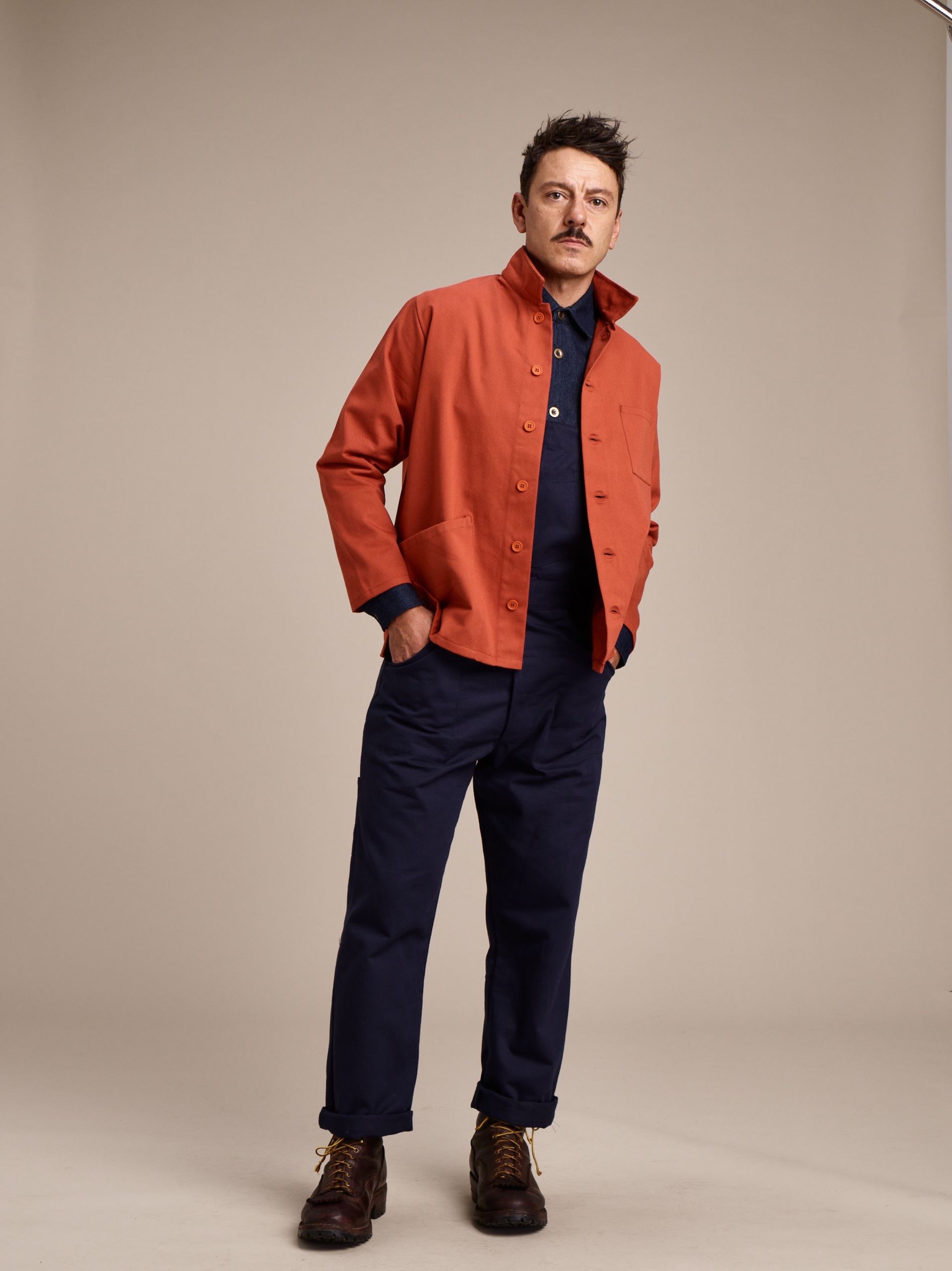 Man wearing Carrier Company Men's Dungarees with Orange Work Jacket and Denim Collar Shirt
