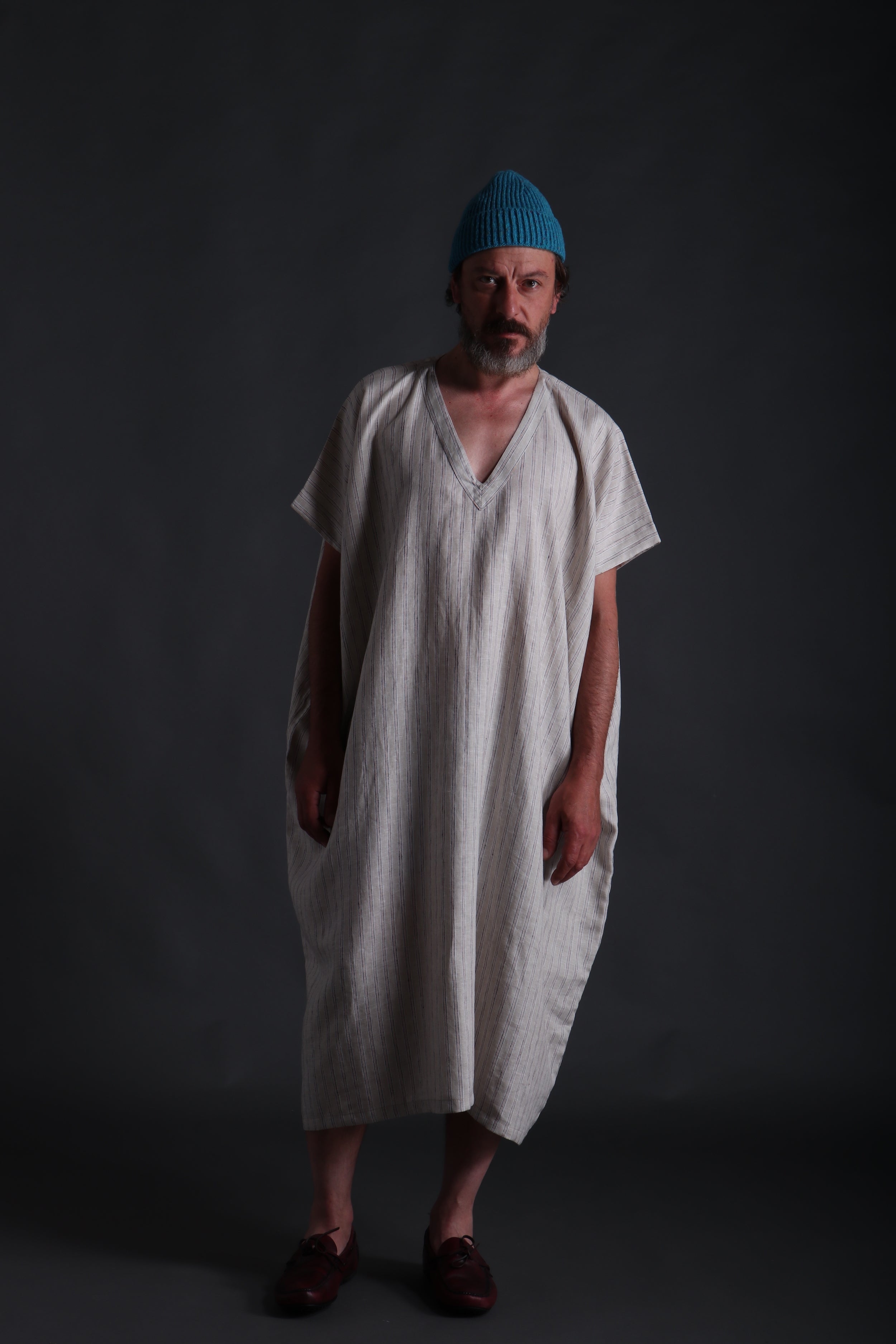 Man wears Carrier Company Dish Dash in Striped Linen with Donegal Wool Hat