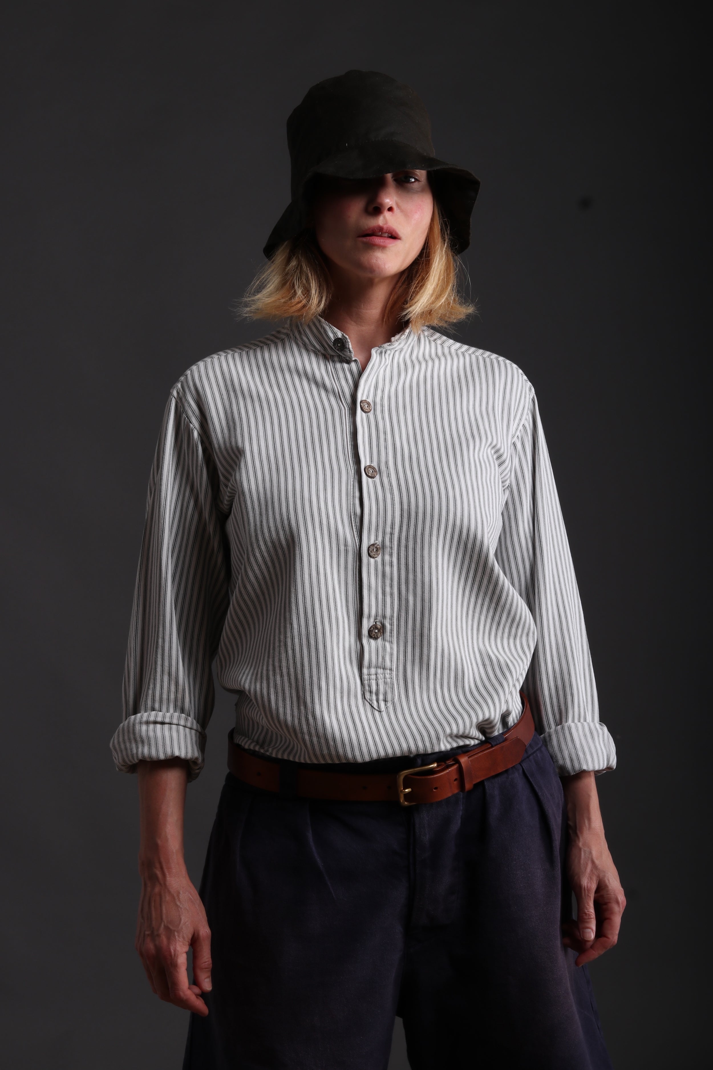Woman wears Carrier Company Grandpa Shorts in Navy with Collarless Ticking Work Shirt