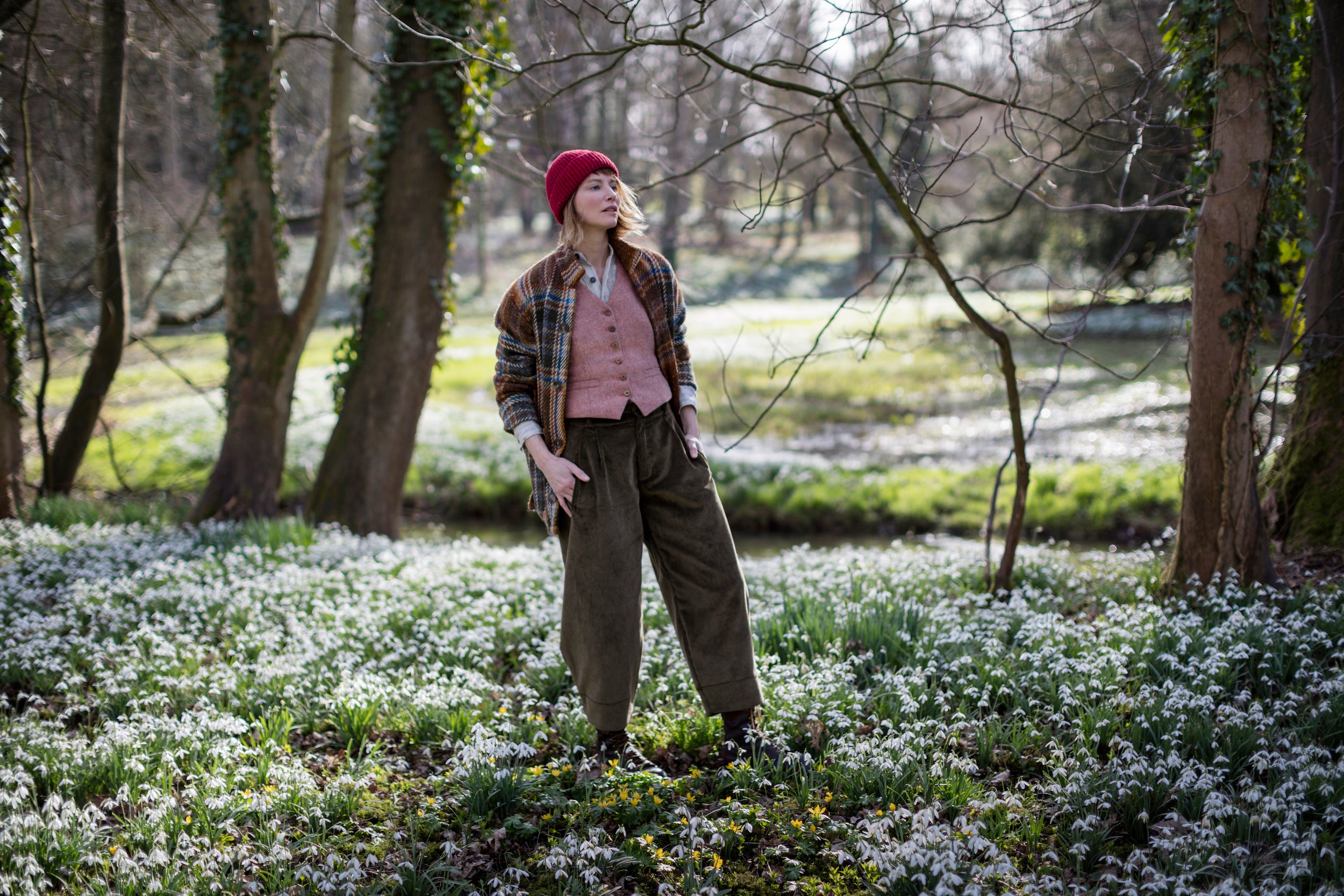 Woman wears Carrier Company Women's Wool Waistcoat in Coral with Celtic Wool jacket in Russet and Dutch Trouser in Corduroy