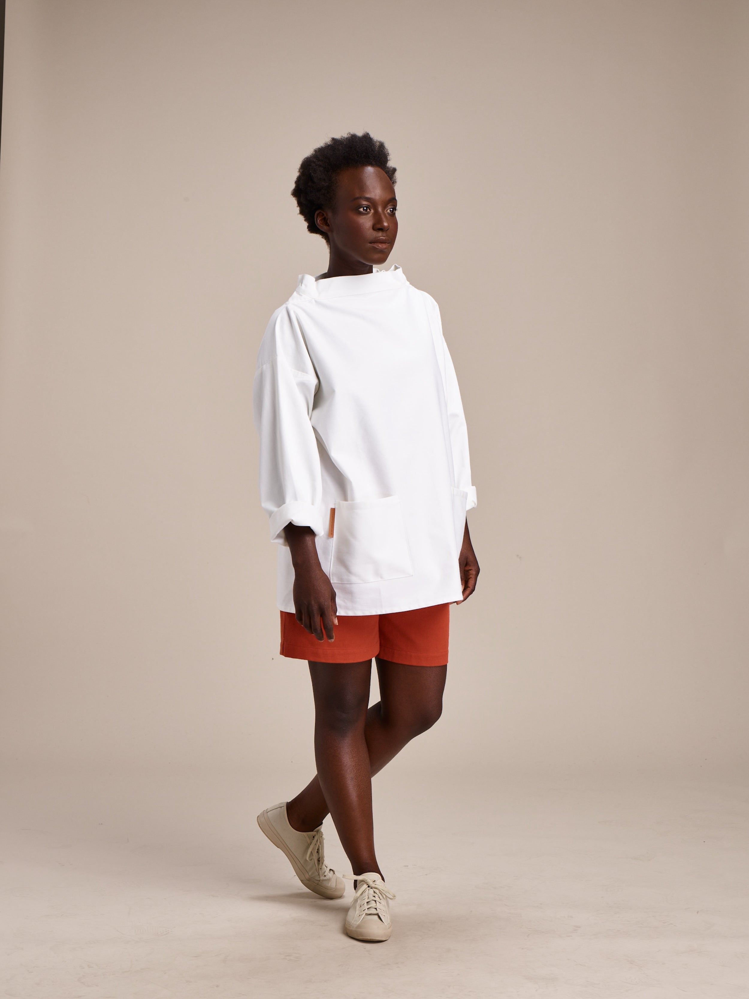 Woman wearing Carrier Company Ladies Shorts in Orange with Traditional Slop in White