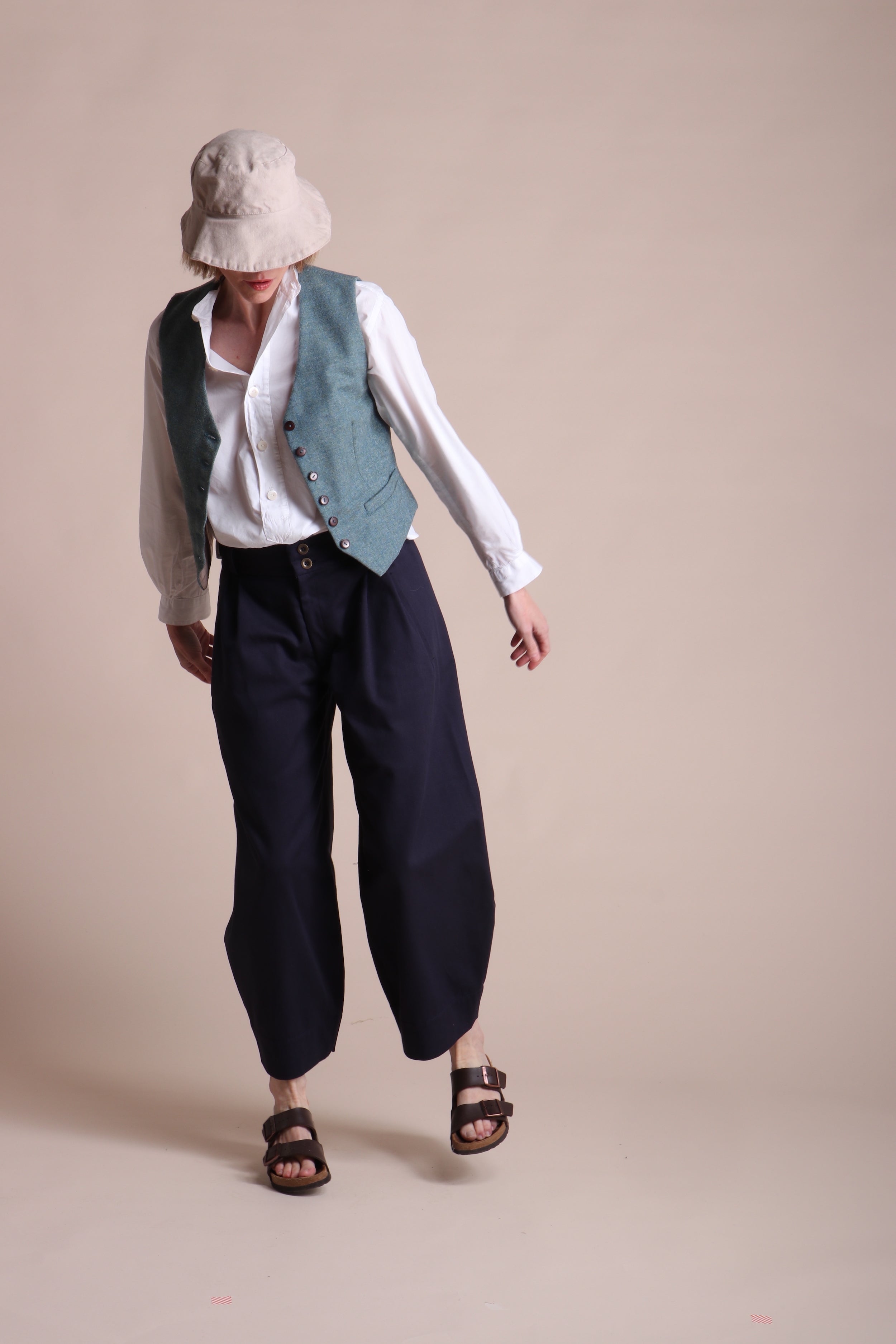 Woman wears Carrier Company Women's Wool Waistcoat in Marine with Lightweight Collarless Shirt and Dutch Trouser in Navy Cotton Drill