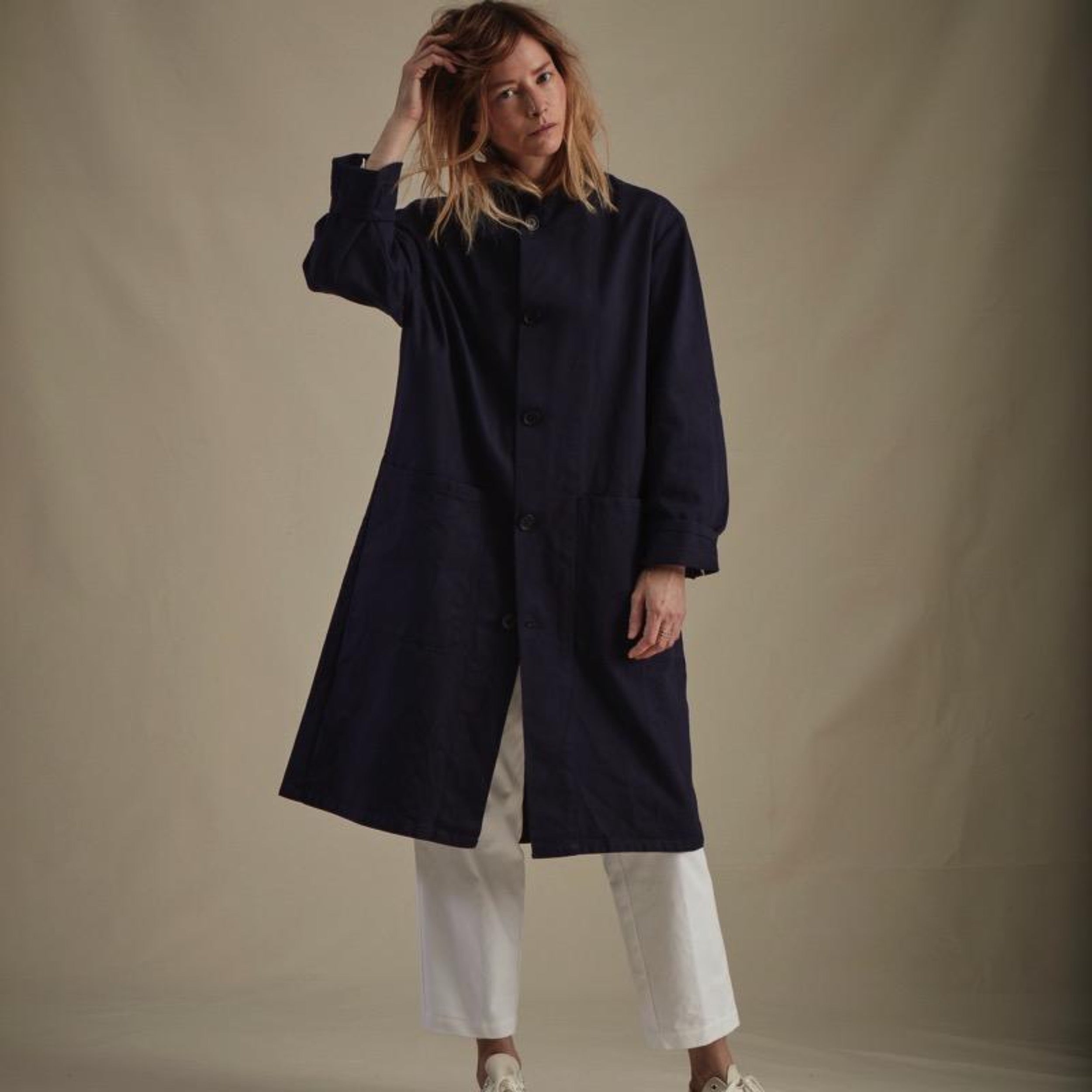 Woman wearing Carrier Company Stockman's Coat in Navy Drill and White Cropped Trouser